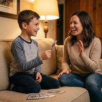 Boy reading a Parent Power-Up card question to his laughing mom on the couch
